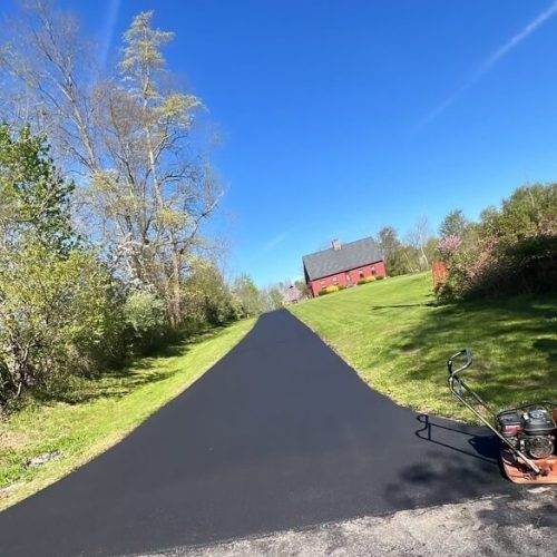 Cooper Paving Specialists fresh paving from a main street to a home