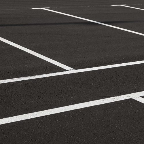 Asphalt commercial paving in a parking lot with durable surface.